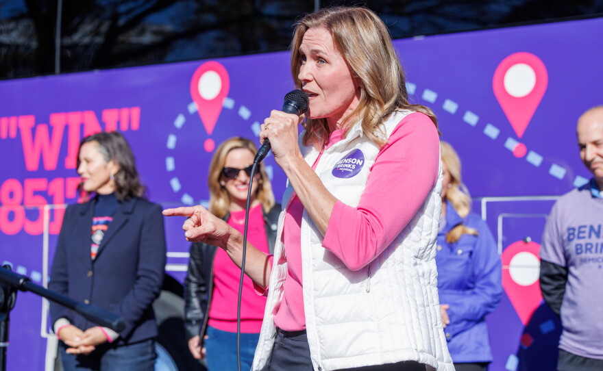 Democratic nominee for lieutenant governor Winnie Brinks speaks in East Lansing, Mich., on Oct. 22, 2026, during the first stop on gubernatorial nominee Jocelyn Benson's statewide "Driving Down Costs" bus tour.