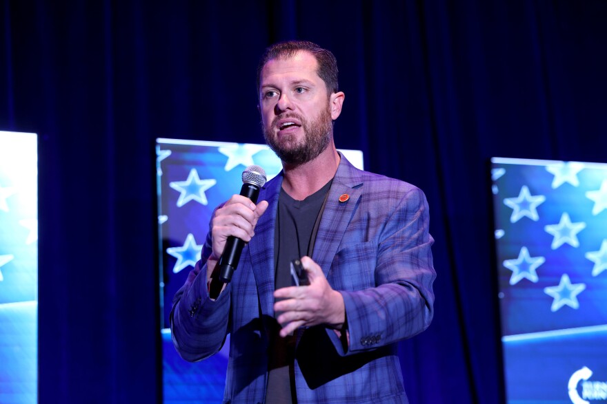 Republican Arizona state Sen. Jake Hoffman speaking with attendees at the 2025 AmericaFest at the Phoenix Convention Center in Phoenix on Dec. 19, 2025.