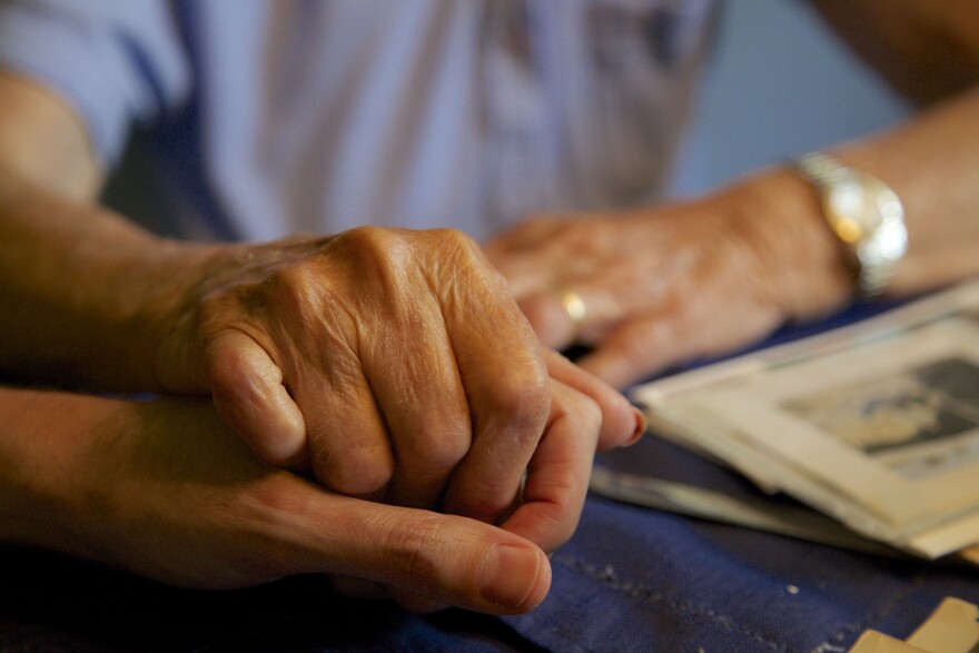 Two people hold hands.