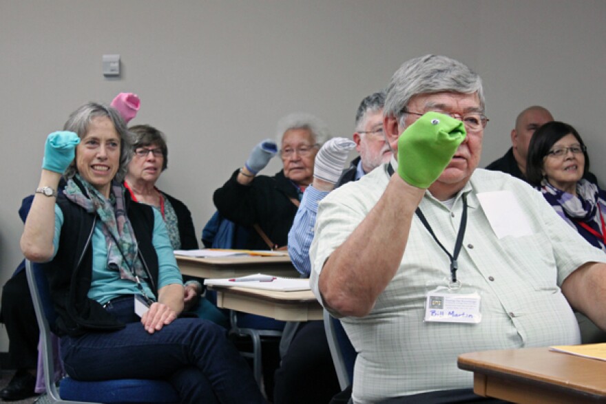 Session participants, including ANB Grand President Bill Martin and poet and translator Richard Dauenhauer, all practiced ventriloquism with sock puppets. Photo by Lisa Phu, KTOO - Juneau.