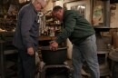 Emory Pineo (L) Owner/Operator of the Antique Stove Hospital repairing oven in workshop with son Brandon (R).