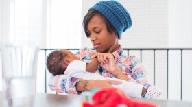 Mom Danielle cradles her baby Kori. Dr. Jim Greenbery says the way African-American women experience healthcare often leads to mistrust with the system and poor outcomes.