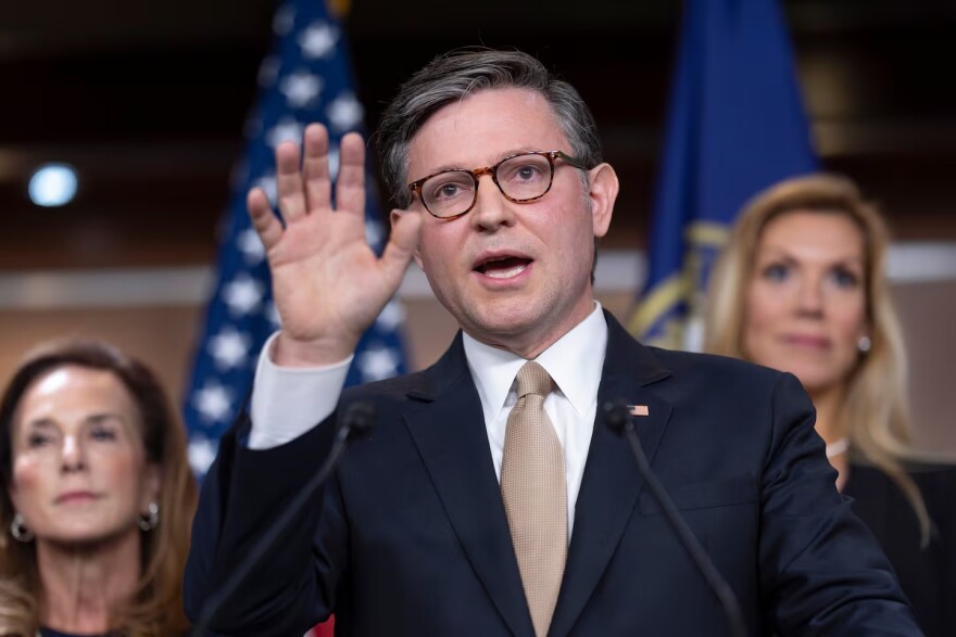 FILE - Speaker of the House Mike Johnson, R-La., flanked by Rep. Lisa McClain, R-Mich., chair of the House Republican Conference, left, and Rep. Beth Van Duyne, R-Texas, talks to reporters after a Republican Conference meeting at the Capitol in Washington, Tuesday, June 30, 2026.