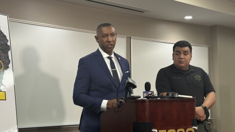 A photo of Forsyth Sheriff Bobby Kimbrough speaking at press conference