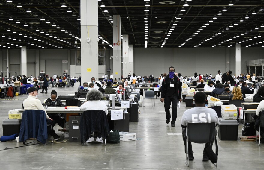 Ballot counters process absentee ballots on Nov. 8 at Huntington Place in Detroit. The scene this year was much calmer than 2020, when protesters descended on Detroit and yelled for election officials to "stop the count!"