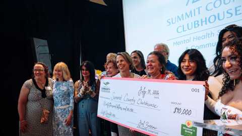 Summit County Clubhouse staff, members, and board members celebrate their award.