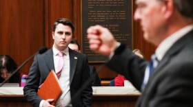 Rep. Andrew Ireland (R-Indianapolis), left, watches as Rep. Matt Pierce (D-Bloomington), right, speaks about SB 326 on the House floor on March 31, 2025.