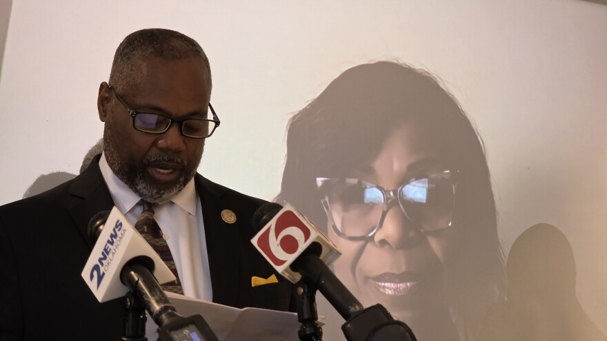 Jeffrey Kennedy (left) speaks to reporters at a press conference in Tulsa on Thursday, July 24, 2025 as fellow plaintiff Rhonda Grayson looks on via video call.