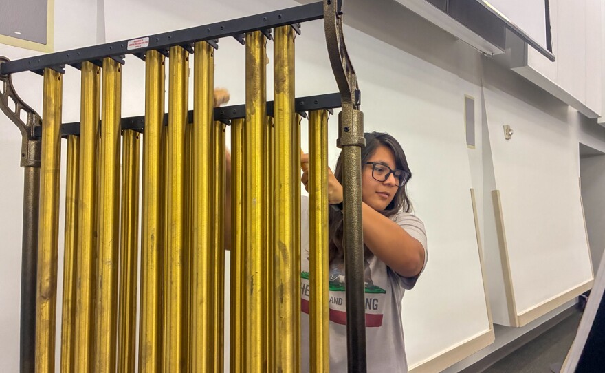 Kayla Solorio plays the chimes during rehearsal for AWC’s semiquincentennial concert. They sound good when they're played right, she remarked.