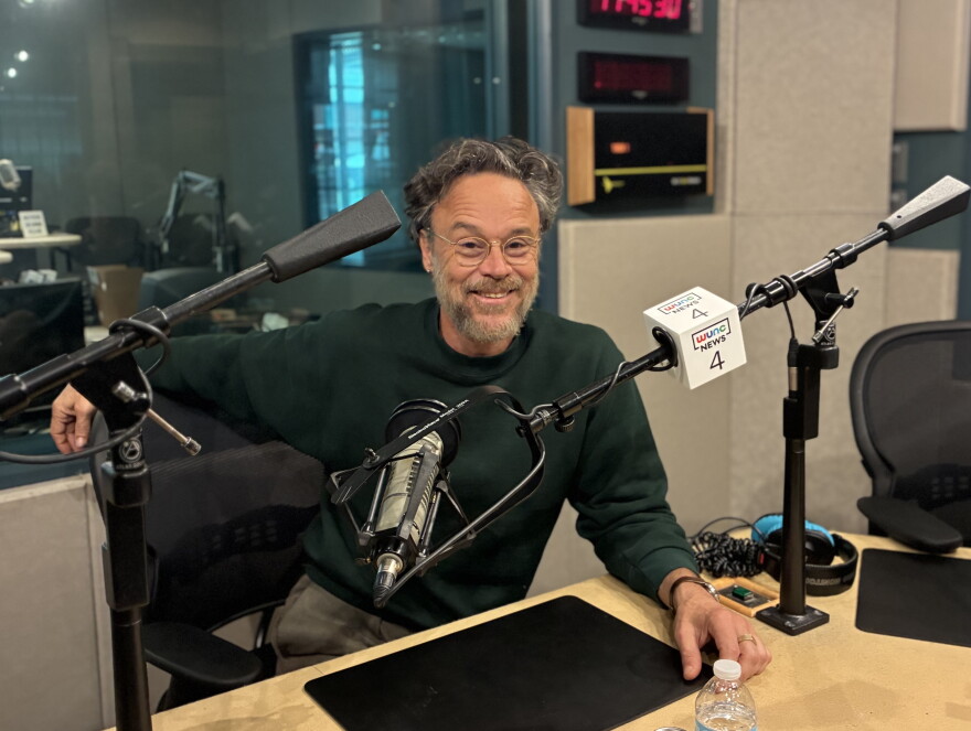 Rodrigo Amarante sitting down for an interview at WUNC’s studios at the American Tobacco Historic District in Durham.