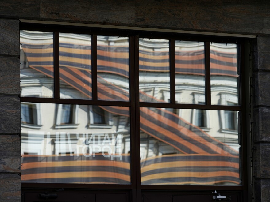 A huge letter Z, which has become a symbol of the Russian military, is reflected in an office building in a street in Moscow, Russia, Friday, May 6, 2022.