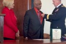 Brigadier General James Robinson, left, pins a medal to Leo Hardin's suit coat as Sen. Claire McCaskill (D-Mo) looks on.