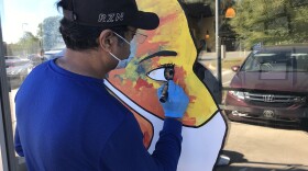 Girish Nair details a new mural outside Tabla Indian Restaurant.