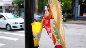 A flag sits at crosswalk in Northside for pedestrians to use to attract a driver's attention that they want to cross the street.