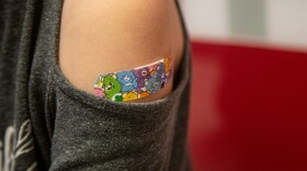 A bandage is placed on Mackenzie Olson, 10, after receiving her COVID-19 vaccination at a pediatrician's office on Wednesday, Nov. 3, 2021, in Decatur, Ga. The U.S. enters a new phase Wednesday in its COVID-19 vaccination campaign, with shots now available to millions of elementary-age children in what health officials hailed as a major breakthrough after more than 18 months of illness, hospitalizations, deaths and disrupted education.