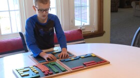 Grant Hartley works with his mom before school every day to improve his reading skills through a special tutoring program.