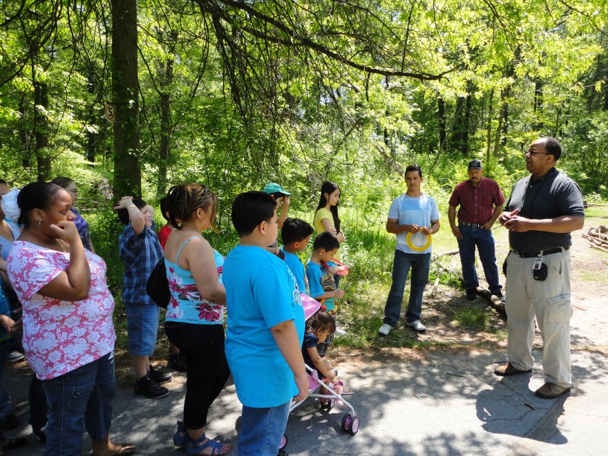 Belle Isle Nature Zoo Manager Mike Reed shows off a new nature trail DPS students helped clear.
