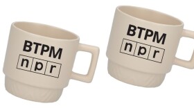 Cream coffee mugs with a black BTPM NPR logo on the center