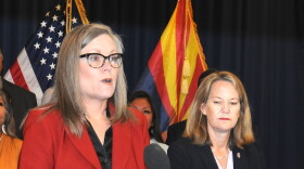 Gov. Katie Hobbs and Attorney General Kris Mayes at a 2023 press conference discussing fraud in the state's Medicaid program.