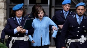 Amanda Knox is led away from an appeals court in Perugia, Italy, in November 2010. Her murder conviction in the death of a flatmate was ultimately overturned, but now, Italy's highest court has ruled she must be retried.