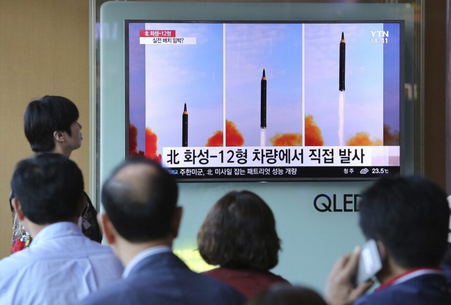 People watch a TV screen  at the Seoul Railway Station in Seoul that shows a local news program reporting about North Korea's missile launch. (Ahn Young-joon/AP)
