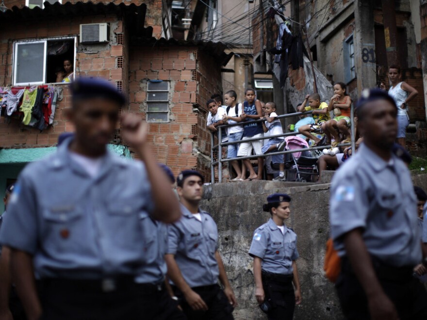 <p>Police officers of the Peacemaker Police Unit program, UPP, patrol the Morro dos Macacos slum last year. The city has stepped up efforts at community policing in order to rid the <em>favelas</em> of drug traffickers.</p>
