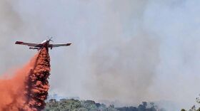 An airtanker helps put out the Spring Creek Fire near Parachute on Sunday, June 25, 2023.