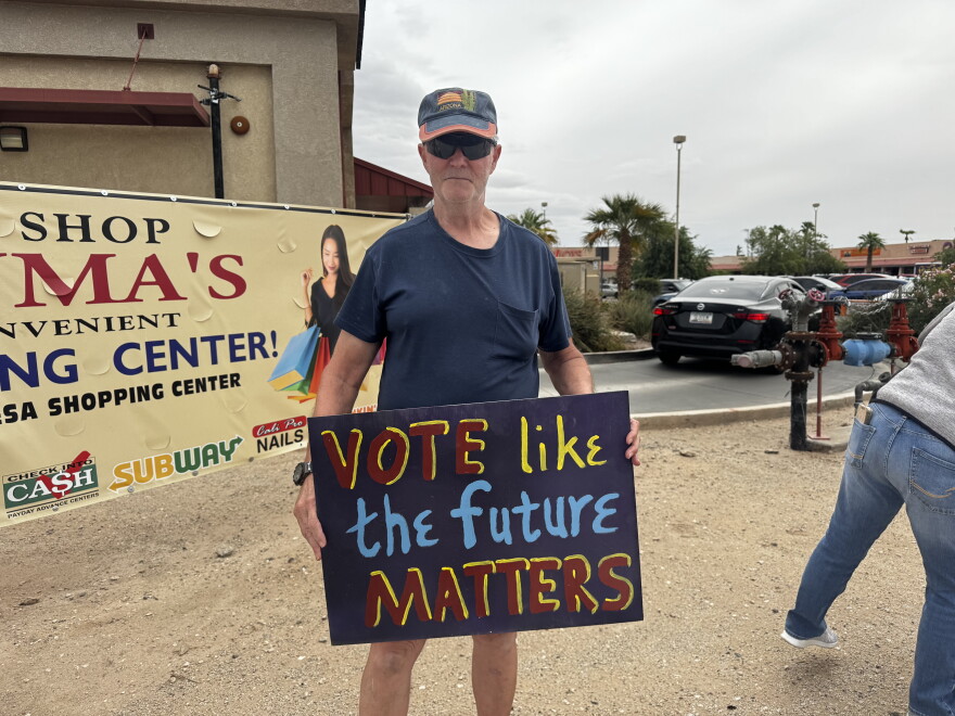 Phil Patch holding his "Vote like the future matters" sign at the No Kings Rally in Yuma.