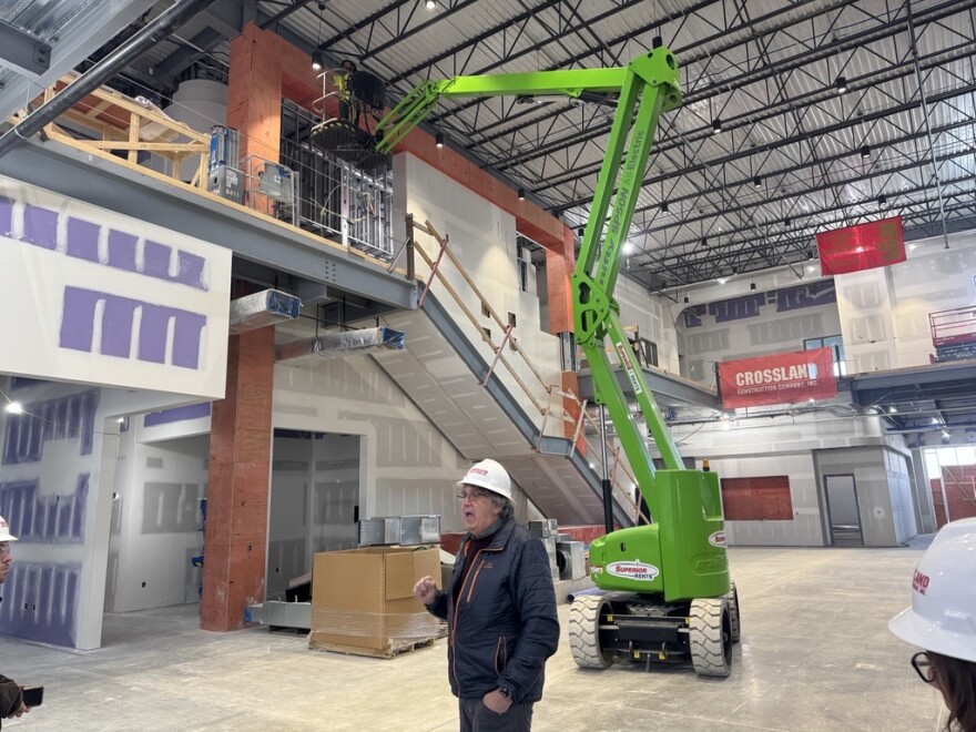 Dean of the Kelce College of Business - Paul Grimes explains the construction plans in the entrance to the active construction site for the new school. He's standing in what he calls 'the living room' of the school.