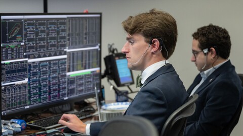 Jack Sieleman sits at a desk in Mission Control.