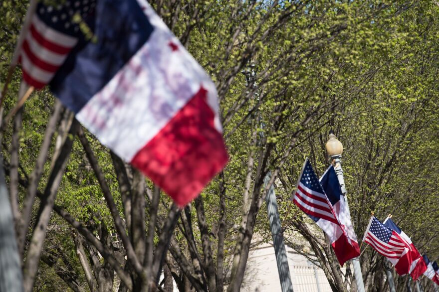 American, French and District of Columbia flags fly near the White House as the capital prepares for an official state visit from French President Emmanuel Macron.