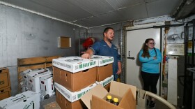 Lenny Burger and Amanda Gordineer look at the small cold storage area Burger's farm. They will add additional cooler space with federal grant money applied for by Food Dignity.