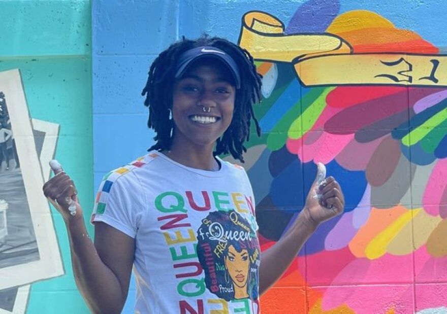 Dunbar resident takes pride in Buck's Backyard Mural at McCollum Hall.