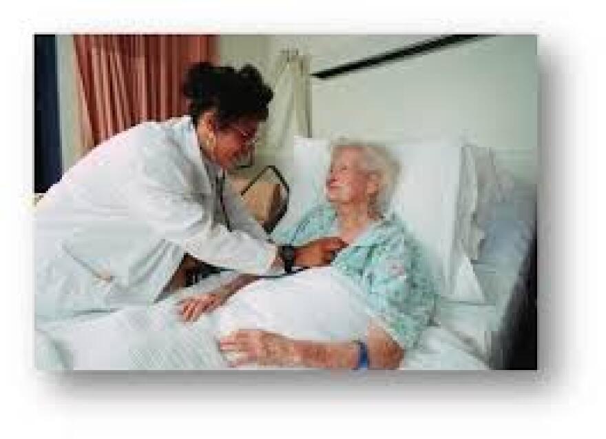 a nurse checks the heart of an elderly patient