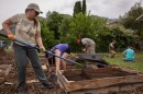 Foodscaping Utah volunteers Michelle Parada, Mar Muster, Mark Lee, John Trimble and Kyra Sutherland work to install a garden in Mark Lee’s front yard in Ogden, May 24, 2025.