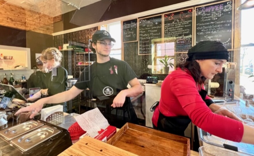 Owners David Berdan and Timea Csibi, working alongside Gracie Jo Cook (far left) to keep up with the orders on a busy afternoon at Chimney Cakes Bakery & Caffe