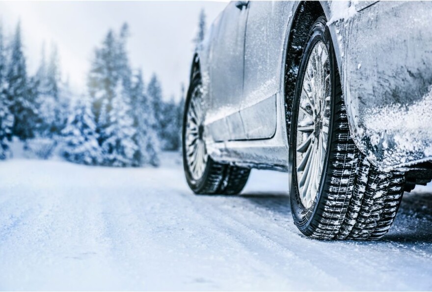 Road-level view of car driving on snowy road