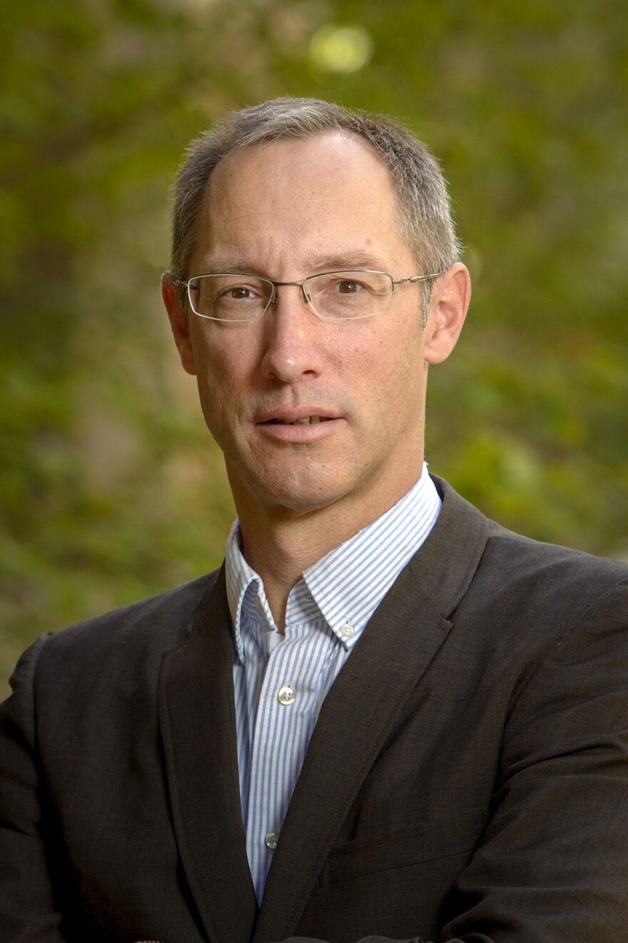 A profile picture of a man in a suit.