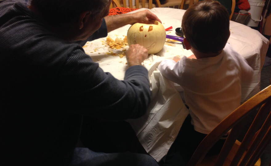 Gary Bolus carves a pumpkin with his grandson, Will Kapmeyer.