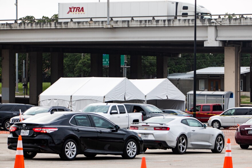 Cars line up for CommUnityCare's drive-thru COVID-19 testing at Hancock Center.