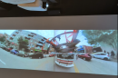 A video still of a fire truck. Projectors are on the ceiling.