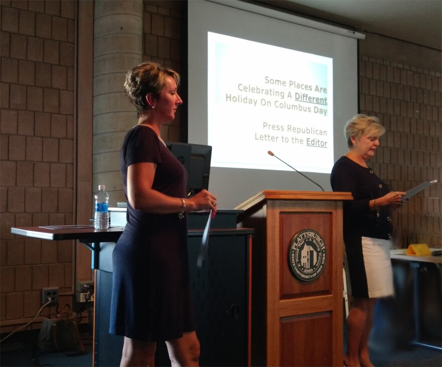 Stafford Middle School teachers Brenda Bieber (left) and Debbie Favro help students with Indigenous People's Day presentation