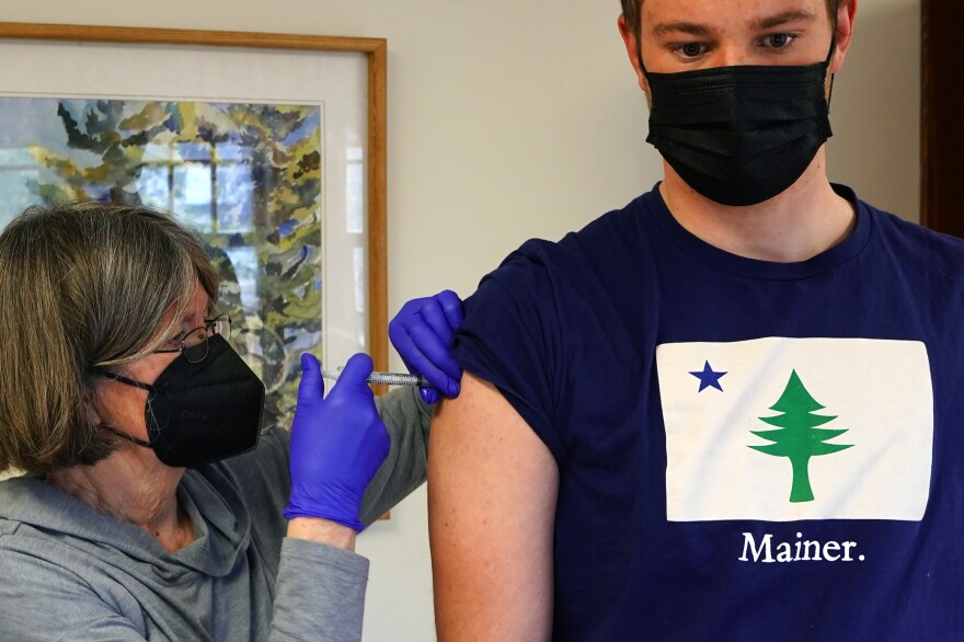 Nurse Sharon Daley administers a COVID-19 vaccination to Oliver Blank, 18, Friday, March 19, 2021, on the island of Islesford, Maine. An exemption has been made to the vaccination age restrictions to allow younger residents on remote islands to receive their shot. (AP Photo/Robert F. Bukaty)