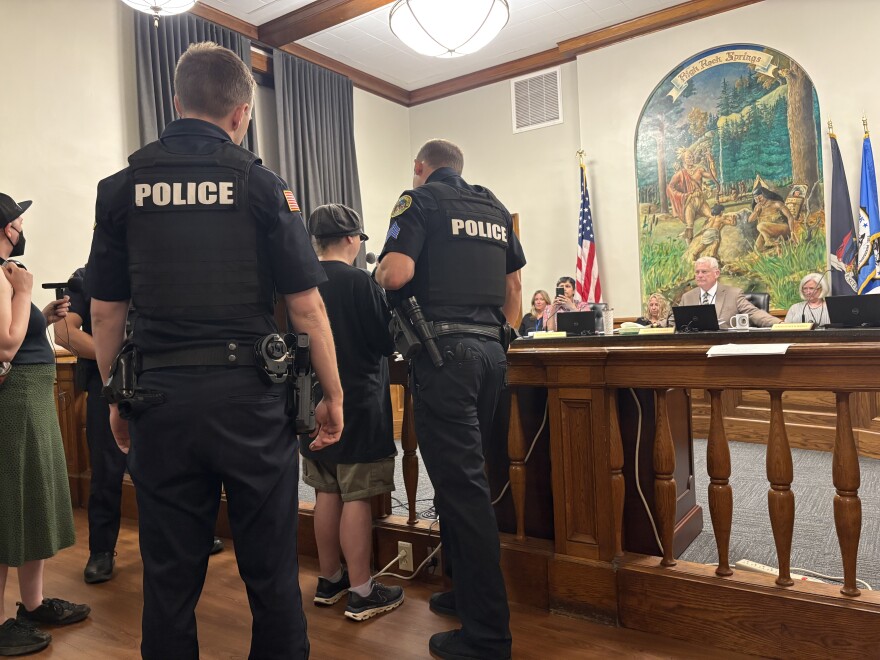 Dio Kaufman was arrested Tuesday night after refusing to step away from the microphone during a public hearing on a proposed camping ban