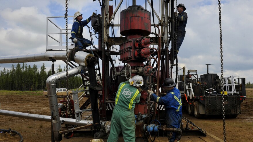 Roughnecks build a drilling rig at the MEG Energy site near Fort McMurray, Alberta, Canada. In addition to large, open-pit mining operations, tar sands oil can be extracted from the ground by pumping down high-pressure steam.