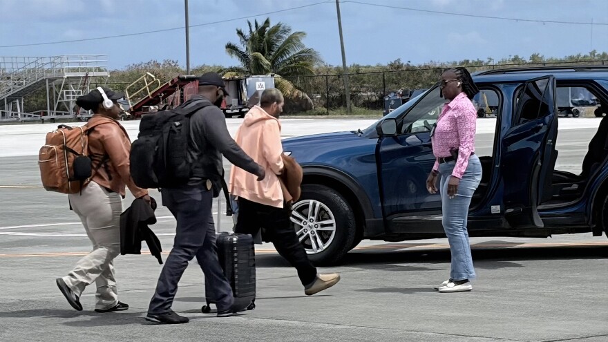 Pictured: Mohammad Suid is escorted by detectives after arriving on a Delta flight to St. Croix on Friday, March 27, where he was taken into custody in connection with a worthless check investigation.