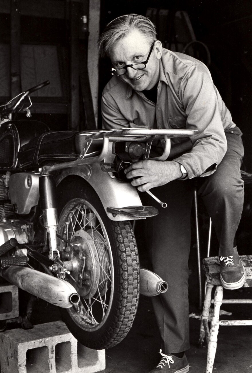 Author Robert Pirsig works on a motorcycle in 1975.