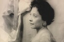 A black and white photo of a woman with short hair facing the left. 