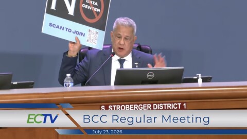Commissioner Steve Stroberger holds 'No data center' sign 