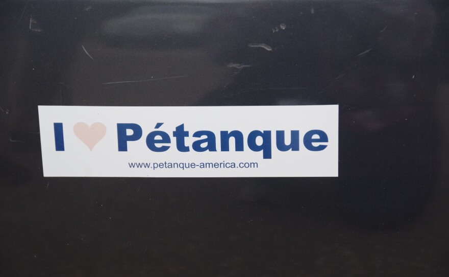 Close up view of a slightly faded bumper sticker that says "I [heart] Pétanque ...www.petanque-america.com"